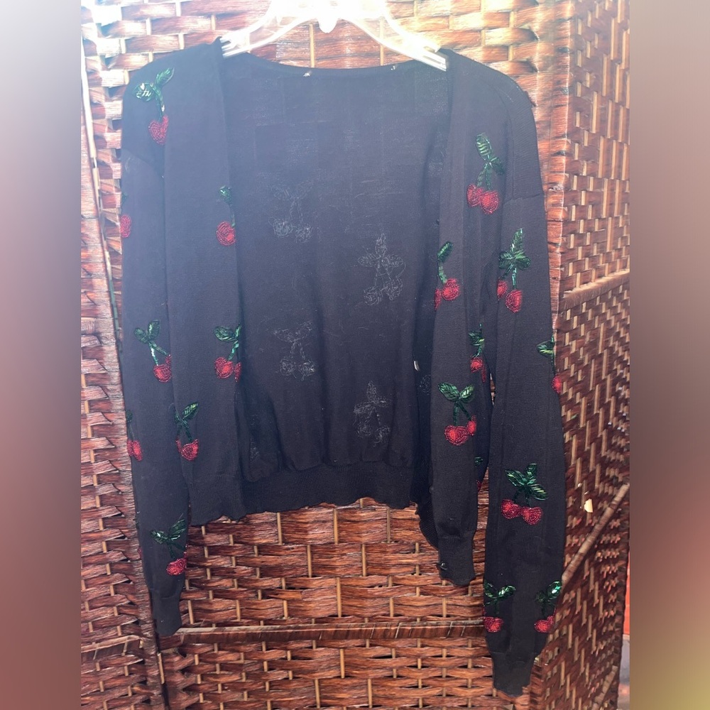 Black sweater with cherry’s on it